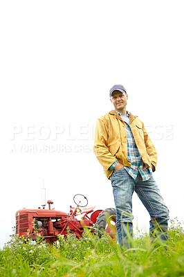 Buy stock photo Full length portrait of a farmer standing in a field with a tractor parked behind him - Copyspace