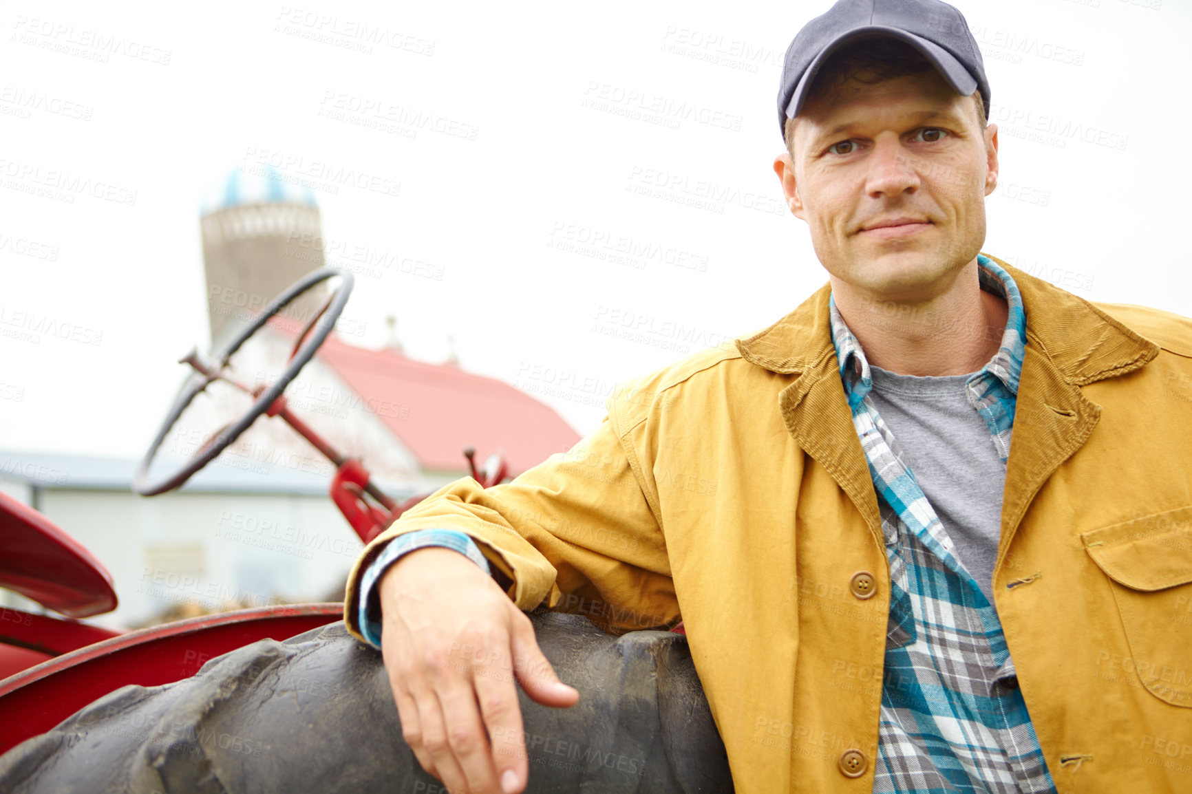 Buy stock photo Countryside, portrait and man with tractor for harvesting, agriculture and tiling for cultivation on farm. Smile, male person and farmer with machine truck for driving, planting and sustainability