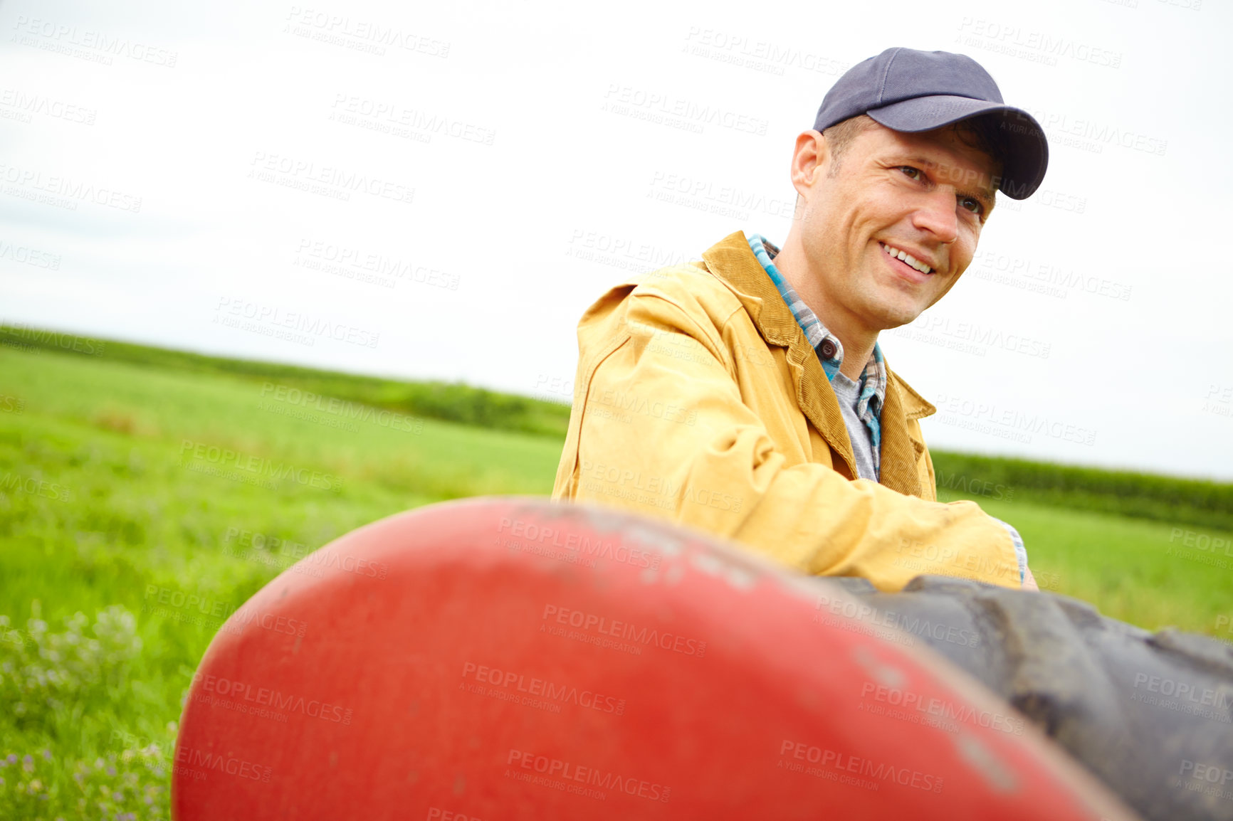 Buy stock photo Farmer, thinking and happy with tractor outdoor for agriculture transport, harvest industry and sustainability. Man, machine truck and environment with field production, eco friendly and countryside