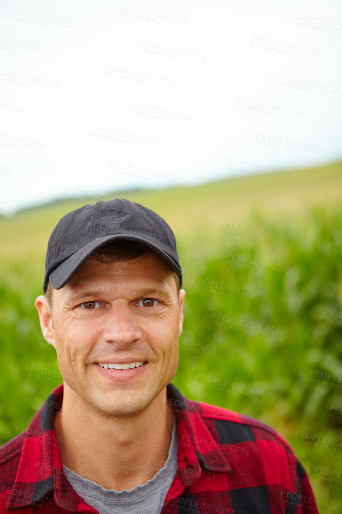 Buy stock photo Man, agriculture and portrait with smile on field, pride or food production with sustainability in countryside. Person, farmer and small business owner in nature, excited or growth for crops in Spain