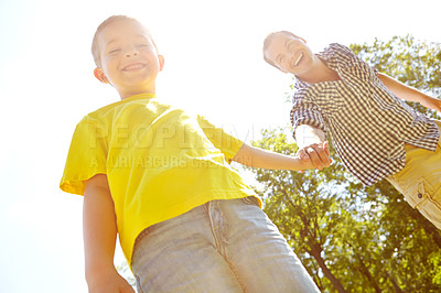 Buy stock photo Games, father and boy holding hands in park for low angle fun, playing and family bonding in nature garden. Space, happy and son with single parent, dad and man in backyard for summer break.