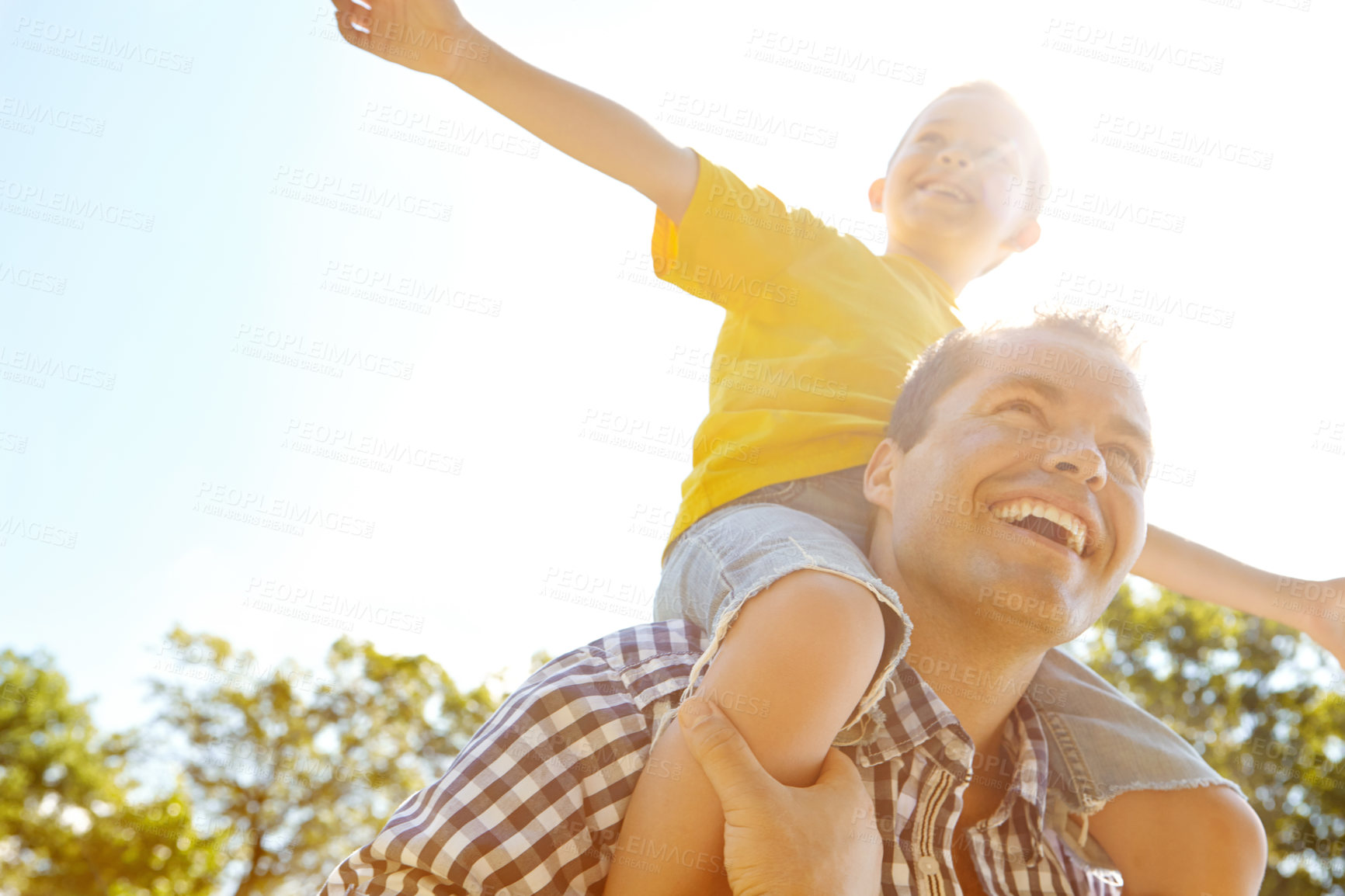 Buy stock photo Father, boy or carrying on shoulders in park for fun games, summer break or bonding in low angle space. Laughing, airplane or son and single parent, dad or man in nature, garden or family backyard