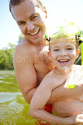 Buy stock photo Cropped shot of a young father and his son in a lake