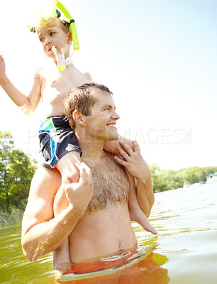 Buy stock photo Lake, swimming and man with child on shoulder for outdoor adventure, love or bonding on vacation. Goggles, happy and father with son in water by nature for summer holiday, support or weekend activity