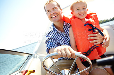 Buy stock photo Young father and son going for a speedboat ride together