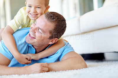 Buy stock photo Happy, father and child play in family home with fun, bonding and love in living room. Smile, wrestling and youth with parent care, support and laugh from game with hug and embrace on the floor