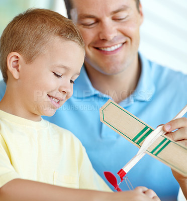 Buy stock photo Airplane, playing and child and dad with toys for fun for bonding, relationship and creativity. Family, happy and boy building model aeroplane with father for games, entertainment and relax in home