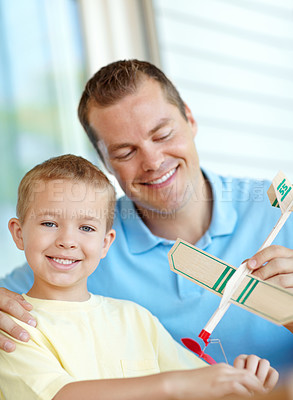 Buy stock photo Airplane, toys and portrait of child and dad for fun for bonding, relationship and creativity. Family, happy and boy building model aeroplane with father for games, entertainment and playing in home