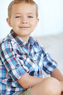 Buy stock photo Portrait, home and cute with boy, smiling and relax with weekend break in living room. Face, youth and peaceful with kid, childhood and joyful with fun, casual and t shirt with happiness and calm