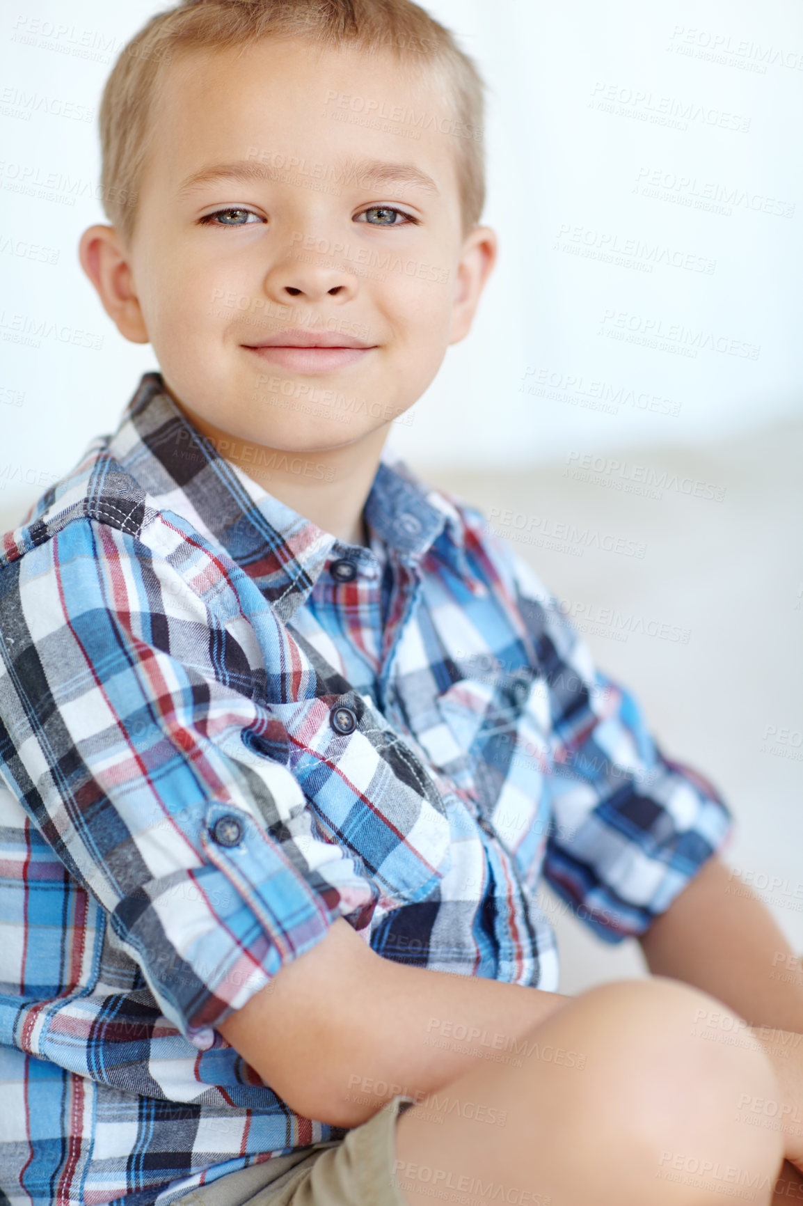 Buy stock photo Portrait, home and cute with boy, smiling and relax with weekend break in living room. Face, youth and peaceful with kid, childhood and joyful with fun, casual and t shirt with happiness and calm