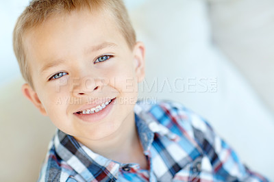 Buy stock photo Happy, sweet and portrait of kid in home with positive attitude for childhood development. Smile, cute and face of young adorable boy from Germany with relaxing on sofa in living room at house.