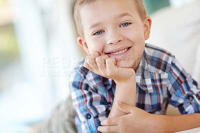 Buy stock photo Happy, cute and portrait of kid in home with positive attitude for childhood development. Smile, sweet and face of young adorable boy from Germany with relaxing on sofa in living room at house.