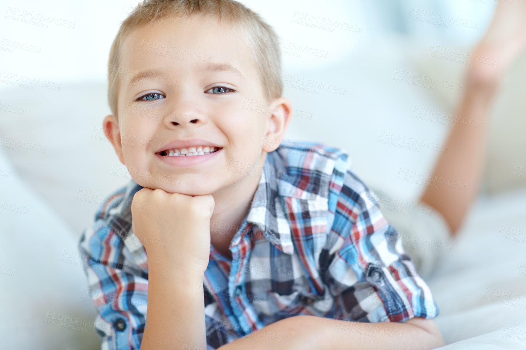 Buy stock photo Happiness, sweet and portrait of kid in home with positive attitude for childhood development. Smile, cute and face of young adorable boy from Germany with relaxing on sofa in living room at house.