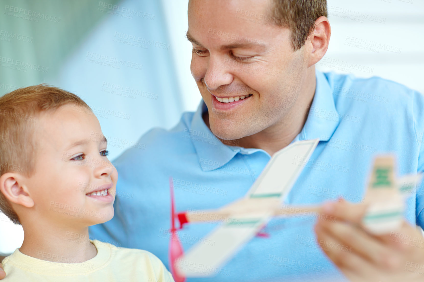 Buy stock photo Airplane, playing and dad with kid for fun with dad for bonding, relationship and development. Family, creative and father with boy building model aeroplane for games, entertainment and relax in home