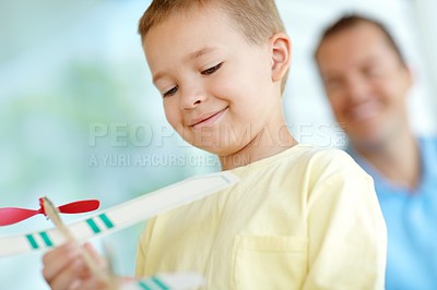 Buy stock photo Toys, boy and dad with airplane, smile and fun on patio together for playful morning bonding. Playing, adventure game and happy child on porch with paper plane, father and son in weekend home