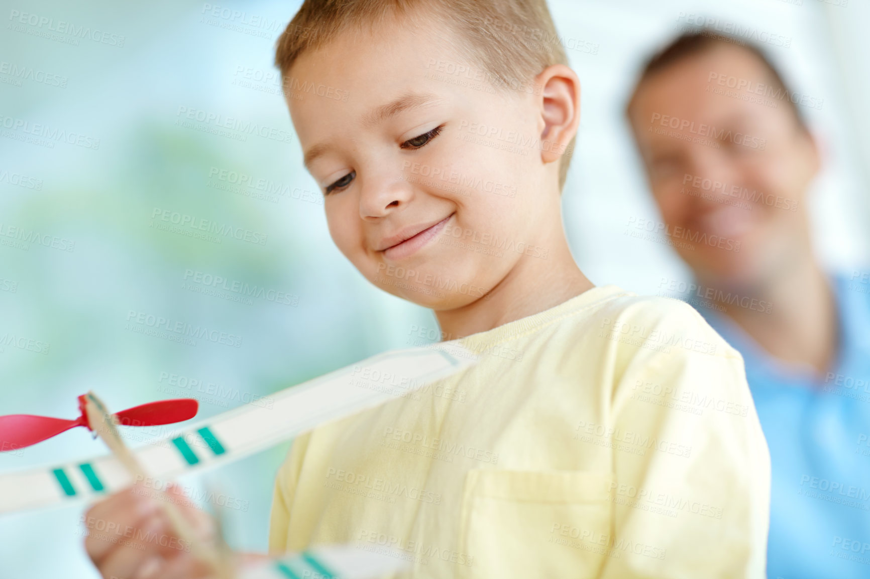 Buy stock photo Toys, boy and dad with airplane, smile and fun on patio together for playful morning bonding. Playing, adventure game and happy child on porch with paper plane, father and son in weekend home