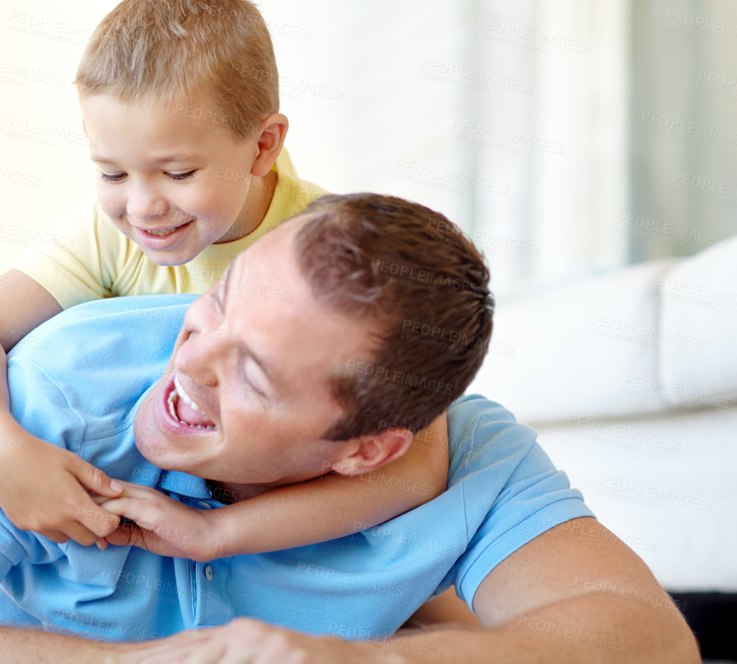 Buy stock photo Happy, father and child wrestling in family home with fun, bonding and love in living room. Smile, playing and youth with parent care, support and laugh from game with hug and embrace on the floor