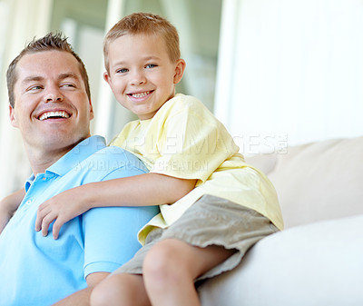 Buy stock photo Boy, dad and hug on couch with smile for portrait in home, bonding or love with support for connection in morning. Child, dad and happy man with security, pride and relax at family house in France