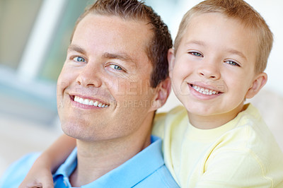 Buy stock photo Boy, dad and happy with hug in home for portrait, bonding or love with support for connection in morning. Child, dad and man with smile for security, playful and piggy back at family house in France