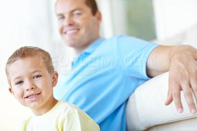 Buy stock photo Boy, dad and relax on sofa in home for portrait, bonding and love with smile for connection in morning. Child, father and happy man for security, playful and care in lounge at family house in France