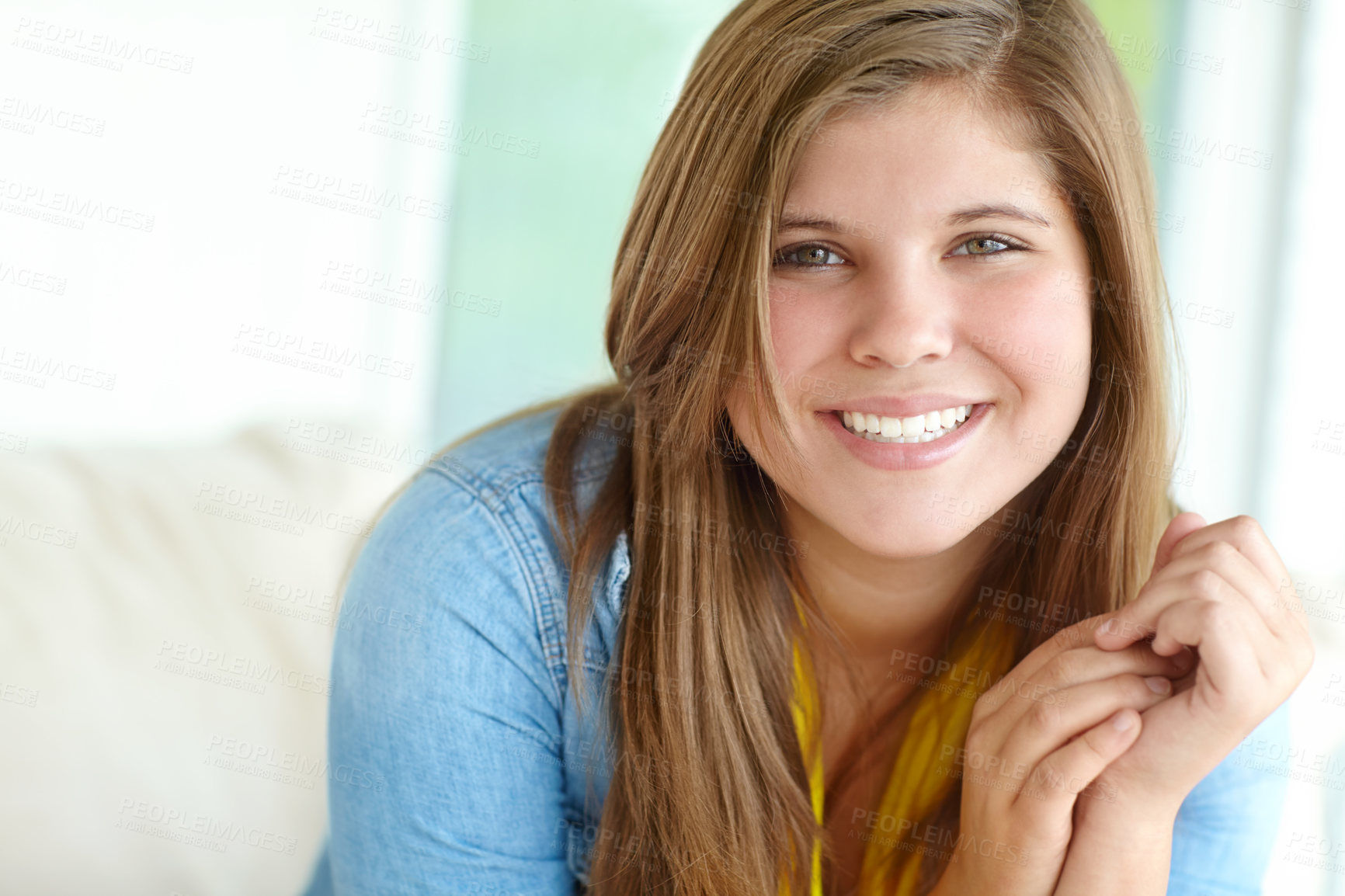 Buy stock photo Girl, portrait and teenager relax on sofa, peace and confident adolescent in living room. Female person, comfortable child and proud smile on weekend in apartment, home and morning satisfaction