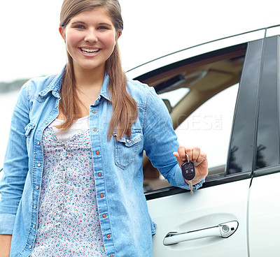 Buy stock photo Happy girl, portrait and car with keys for new ride, asset or vehicle privileges in neighborhood. Young, female person or driver with smile by window for transport service, commute or travel access