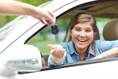 Buy stock photo Happy girl, portrait and car with keys for purchase, asset or vehicle privileges in neighborhood. Young, female person or driver with smile by window for transport service, commute or motor ownership