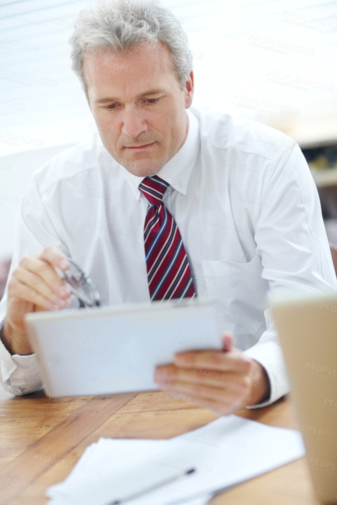 Buy stock photo Mature businessman, tablet or reading digital financial reports for company future, investment or growth. Office finance manager, technology or software for corporate portfolio, revenue or planning