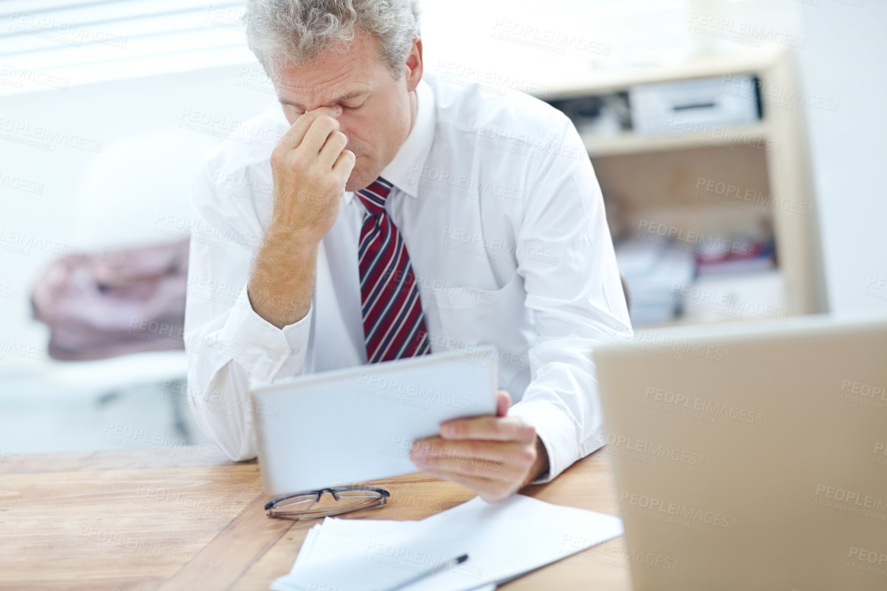 Buy stock photo Mature, businessman and headache with tablet for stress, mistake or financial crisis at office. Senior, man or employee with migraine on technology for bankruptcy, debt or bad news at workplace