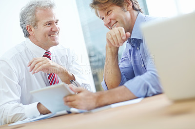 Buy stock photo Two male business associates enjoying a meeting in the office