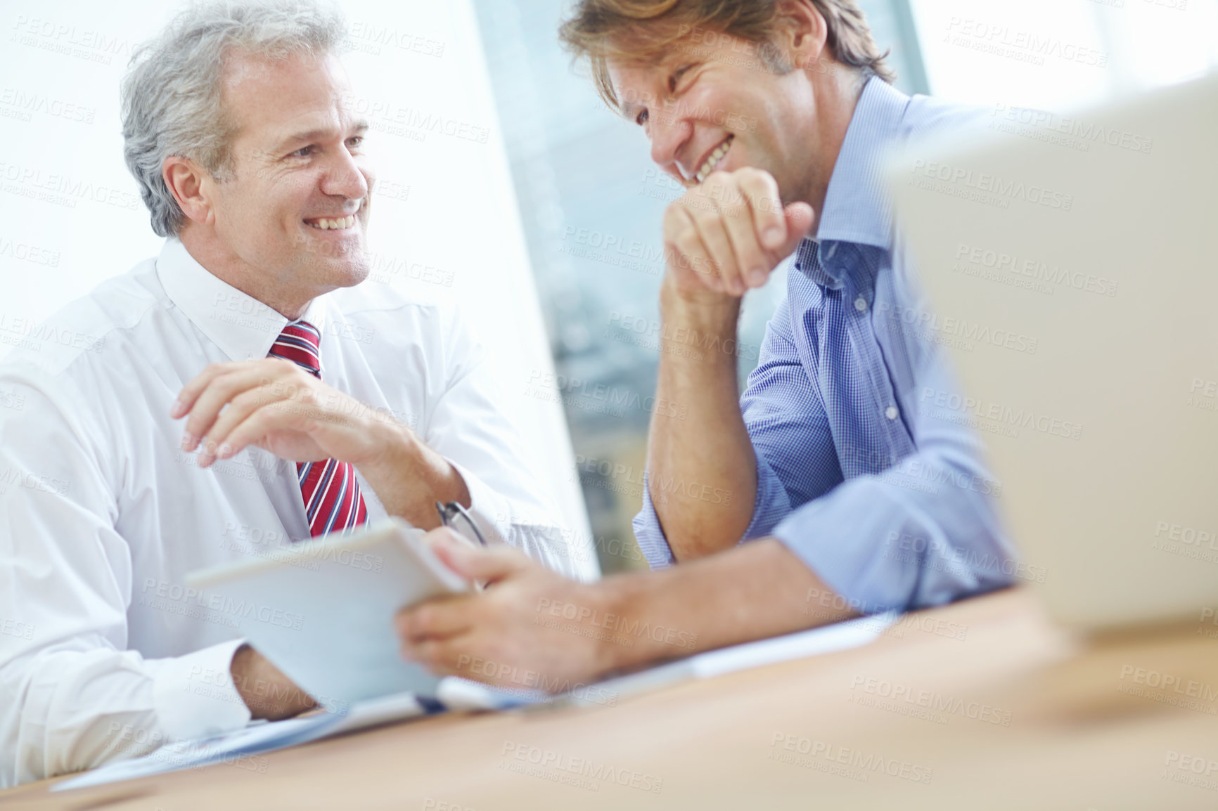 Buy stock photo Two male business associates enjoying a meeting in the office