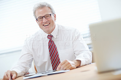 Buy stock photo Mature, attractive male business associate expressing positivity in the office