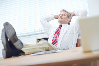 Buy stock photo Mature, attractive businessman relaxing in an office chair