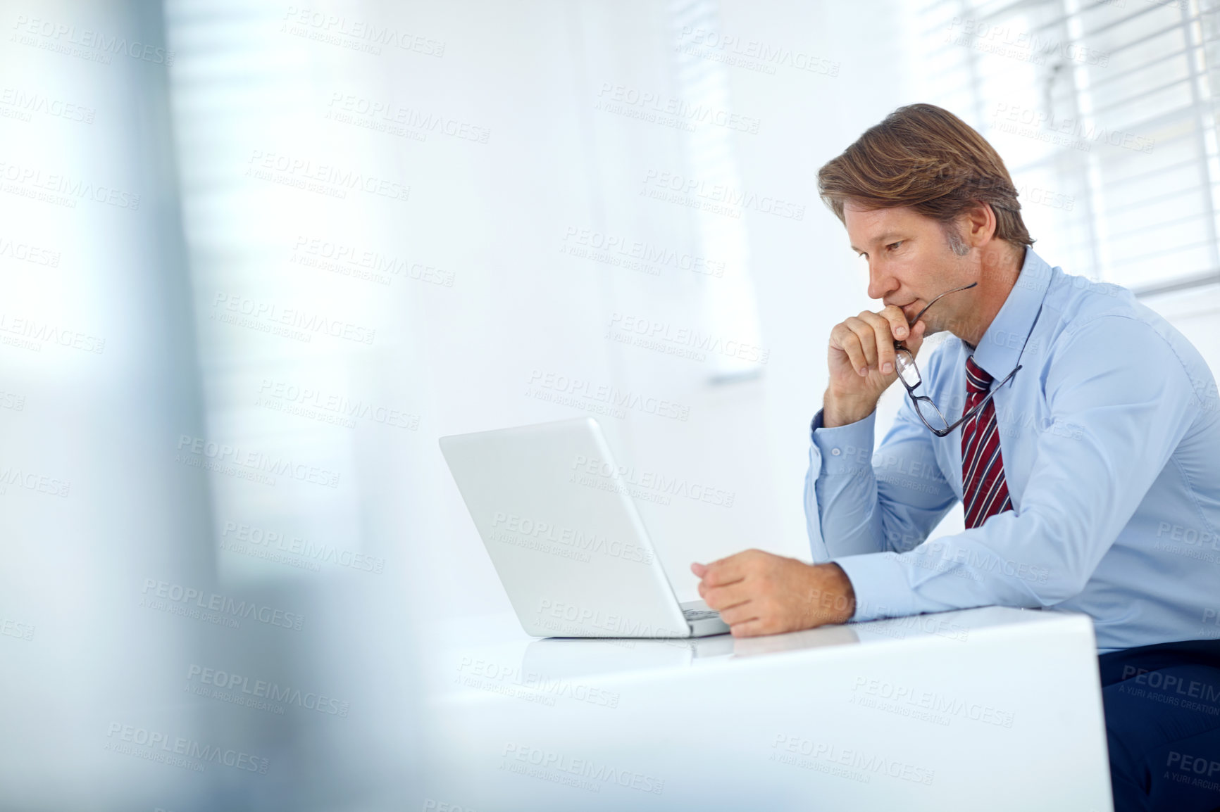 Buy stock photo Shot of a mature businessman working at his computer