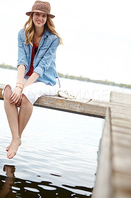 Buy stock photo Portrait, woman and jetty on lake for travel, break or holiday with happiness, feet or relax. Female person, smile and vacation on pier for freedom, outdoor adventure or peace as tourist in Indonesia