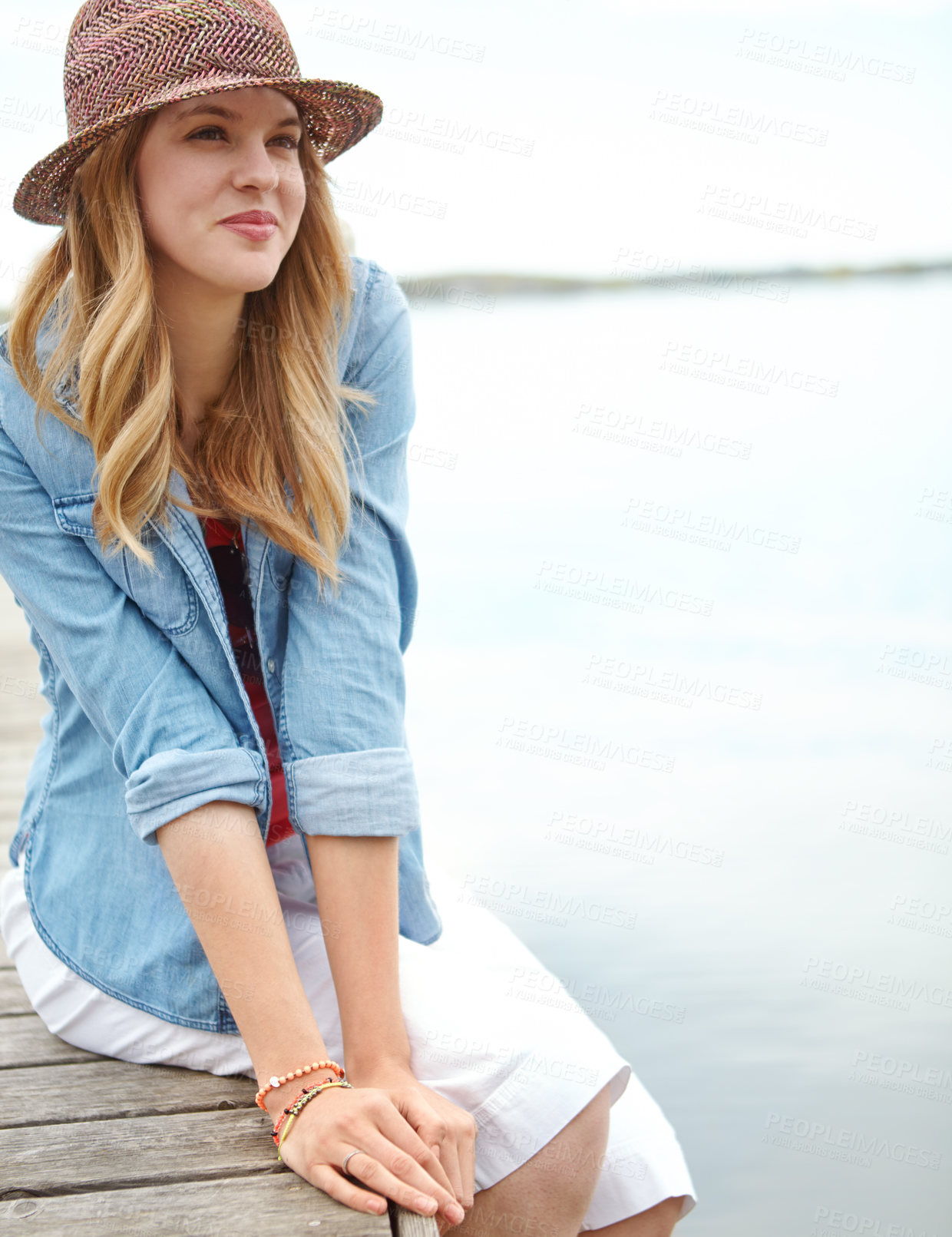 Buy stock photo Thinking, woman and jetty for vacation, break or holiday with happiness, sky and relax on lake. Female person, smile and travel on pier for freedom, outdoor adventure or peace as tourist in Indonesia