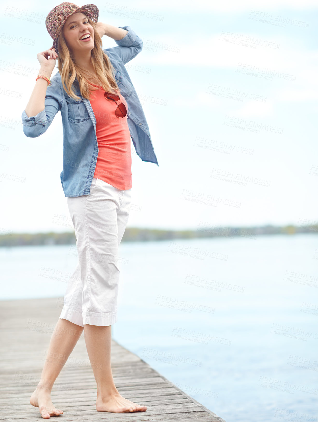 Buy stock photo Holiday, fashion and portrait of girl on pier with smile, relax and outdoor adventure in nature. Dock, lake and happy woman on travel vacation with casual style, confidence and calm morning in Canada