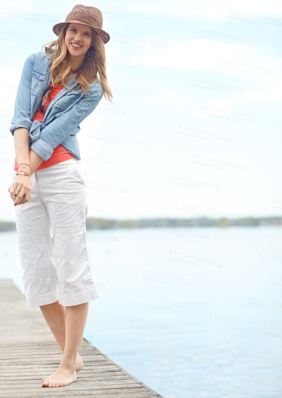 Buy stock photo Vacation, fashion and portrait of happy woman on pier with smile, relax and outdoor adventure in nature. Dock, lake and girl on travel holiday with casual style, confidence and calm morning in Canada