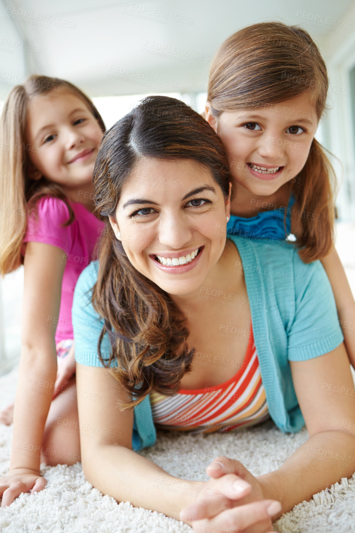 Buy stock photo Playful, children and portrait with mother on floor for development, support and bonding on weekend. Family love, fun and kids with smile by woman at home for care, connection and relaxing together