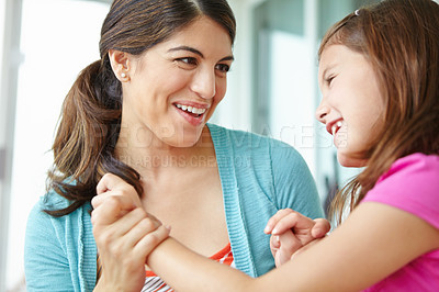 Buy stock photo Playing, mom and fun with child, affection and bonding with daughter, love or comfort for girl and family. Laughing, mother and care for kid, relax and motherhood for woman, adoption or games in home