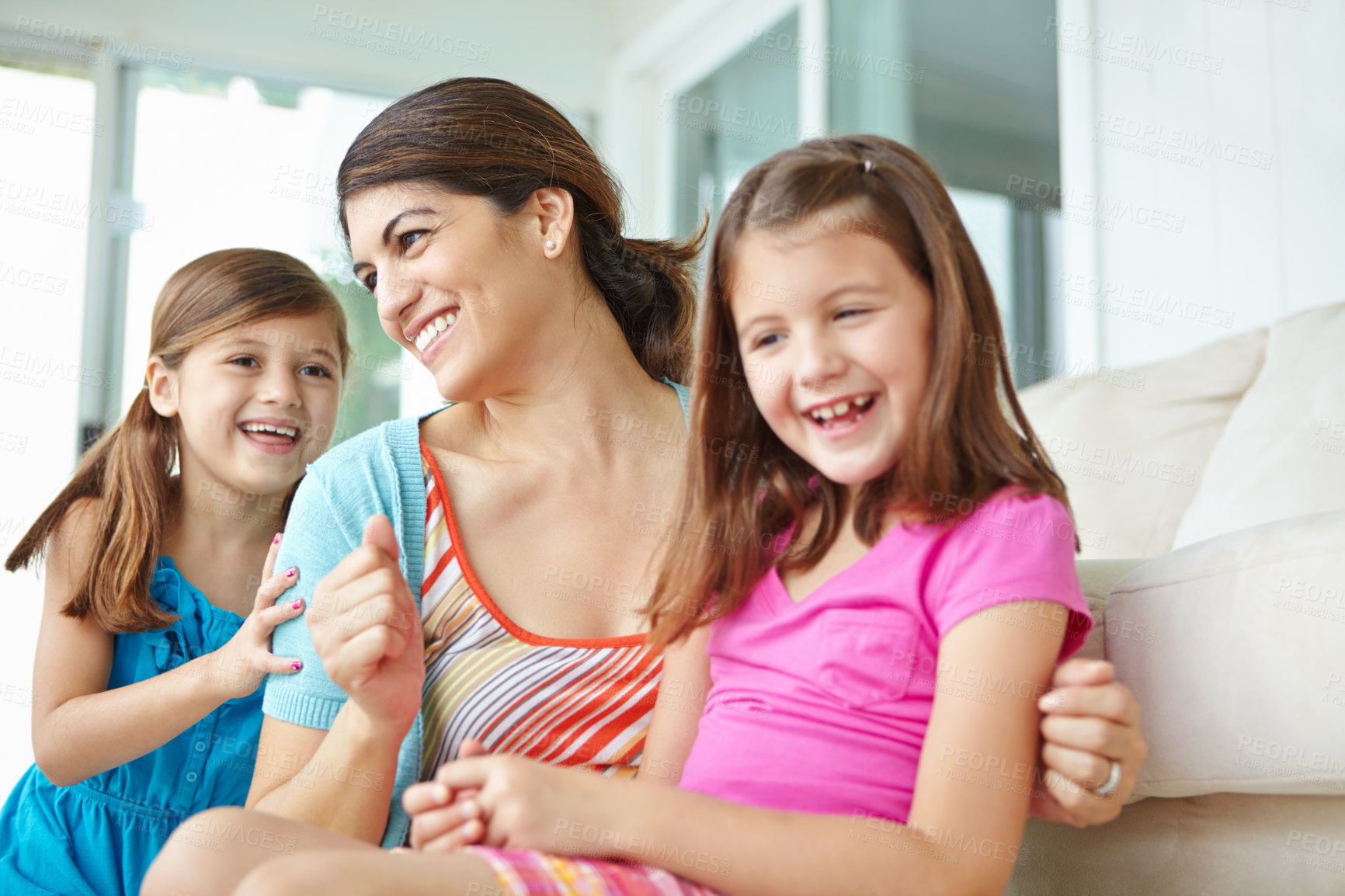 Buy stock photo Family, children and happy with mother on sofa for support, development or bonding on weekend. Laugh, love and girl kids with smile by woman at home for care, connection or relaxing with fun together