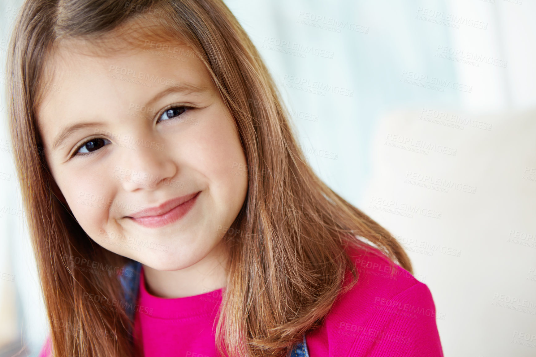 Buy stock photo Girl, happy and portrait of child on sofa for fun on weekend in living room of house or home. Smile, satisfaction and face of female kid alone on couch for happiness, comfort and childhood in Spain