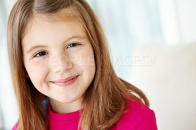 Buy stock photo Girl, smile and portrait of child on sofa for fun on weekend in living room of house or home. Happy, satisfaction and face of female kid alone on couch for happiness, comfort and childhood in Spain