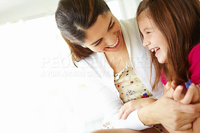 Buy stock photo Fun, mom and love for child, tickling and bonding with daughter, house and games with girl and family. Laughing mother and care for kid, relax and motherhood for woman, adoption and together in home