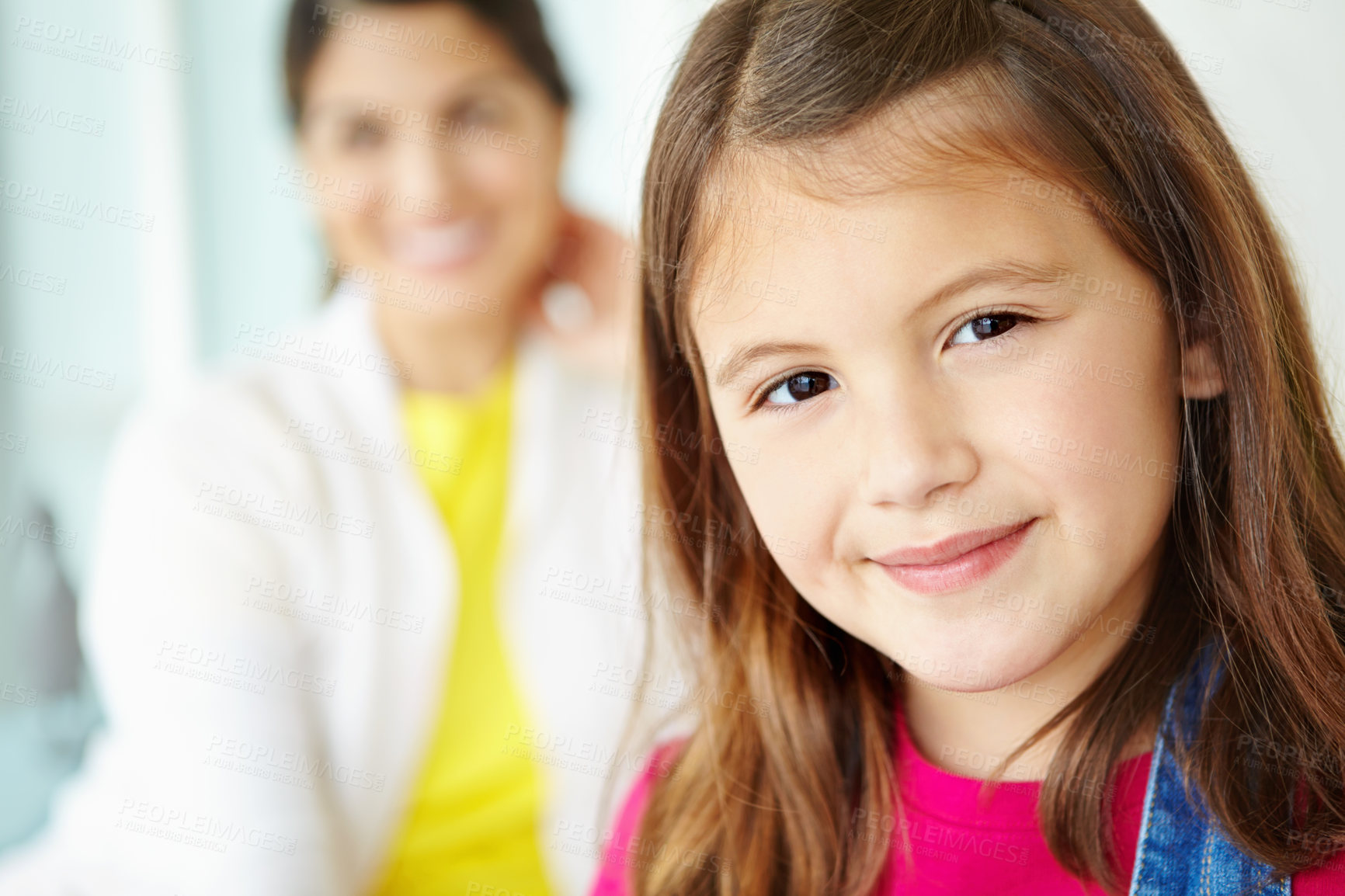 Buy stock photo Blur, mom and portrait of girl in home for fun or development in living room of family house. Smile, relax or face of confident kid on couch with parent for happiness, comfort and childhood in Spain