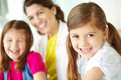 Buy stock photo Happy family, home or portrait of girl laughing with support or development in living room for love. Relax, sisters or confident girl bonding with siblings or parent blur for happiness or comfort