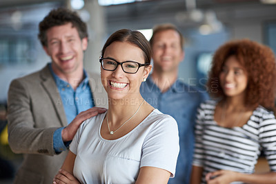 Buy stock photo Portrait of a smiling businesswoman with supportive colleagues behind her
