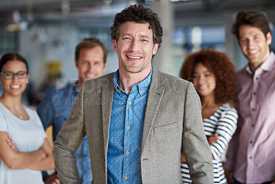 Buy stock photo Mature man smiling at the camera with his proud staff behind him