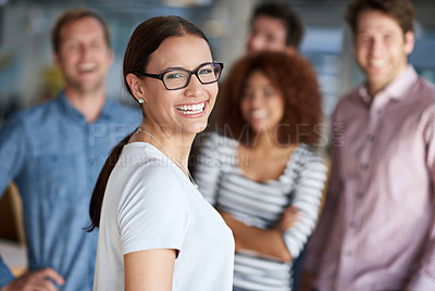 Buy stock photo Beautiful businesswoman smiling with friendly coworkers in the background