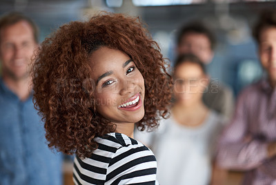 Buy stock photo Beautiful businesswoman smiling with friendly coworkers in the background
